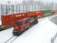 Canadian Tire is a big client of CP's and here some of their container passes CP 8046 as CP 112 works Lachine IMS Yard as the snow falls.