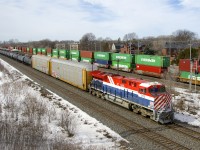 Heritage unit CN 3115 leads CN X306 east, with CP 112 at right heading in the same direction on the parallel Vaudreuil Sub.