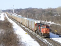 CN X322 has a train of solid autoracks as it passes through Beaconsfield with CN 5619 & CN 2183 for power.