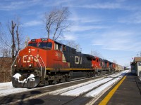 CN 305 is passing St-Lambert Station after adding CN 2618 as the new leader and doing a TIBS test. Trailing are CN 2128 & CN 8929.