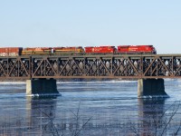 CP 253 is crossing the St. Lawrence River with two CP and two KCS units, split between EMD's and GE's (CP 7033, CP 9633, KCS 4143 & KCSM 4677). At the end of the train are the empty tank cars of CP 651.