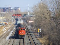 CN 527 with a trio of SD70M-2's is approaching Taschereau Yard as CP 251 appears in the distance with CP 6018 & CEFX 1002, crossing over CN's Montreal Sub on CP's Adirondack Sub.