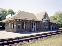 I'm sure most of the railfan wanderers are familiar with this station. It really has not changed all that much in the 45 years since I shot this photo. But it has not been used by CN in many years.
I recall it being a Chamber of Commerce with also MTO offices there. Hunting, fishing licenses also available. They moved out. In 2017 the town offered up the station for sale and it sold for just over $100,000 I understand. Not bad for 2900 sq ft in a solid building such as this. The station was designated architecturally and historically significant in 1983; so the exterior of the building is not to be altered no matter who takes it over. The buyer in 2017 was going to develop a banquet facility there, I heard; but nothing happened. In 2019 a business called "Rainbow Sound" (music and instruments) was going to be open by the fall of that year, but again, nothing happened. I guess a 'cheap' purchase isn't that cheap after all if there is no money coming in at said property. Last I saw of it, Oct 2020; it was empty and for lease.  Beautiful structure, and has held up very well since its' construction back in 1932.