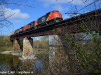 I'd always had it in mind to replicate <a href=http://www.railpictures.ca/?attachment_id=16438 target=_blank>Mr Mooney's shot</a> taken of a CN powered GEXR train in Breslau in 1998 and well, this is the best I could do as it's very overgrown. Once CN took over I knew I had to do it though. This would be the east side of the bridge for an eastbound train. I tried only in the spring or fall due to foliage and it even took a bit of brush clearing to fully clear out this portal. The view from the south west side is also <a href=http://www.railpictures.ca/?attachment_id=32307 target=_blank>rather nice</a> and I even shot <a href=http://www.railpictures.ca/?attachment_id=42902 target=_blank> OSR here</a> as well as passenger trains. Alas, Metrolinx this week has installed permanent fencing on both sides of the bridge and while these shots are very much still possible, it won't be the same. I had a hunch that Metrolinx would do it so I made sure to capture a variety of angles over the last couple of years. More to come :)