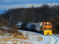 On a late January afternoon I found myself following GEXR 583 northward on the Guelph Junction Railway with clouds to the south, and pure setting sun to the north creating magnificent lighting conditions. 2117 is working hard with five cars as this is one of the good northward grades on GJR. The train is approaching what the railroaders call Danger Bell. In recent years the crossing had large led lights installed to help improve safety. For an explanation of what Danger Bell means, see comment below