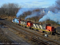 Working hard to pull their loaded Steel Coils from Stelco out of 'the hole' a trio of EMD locomotives are smoking good as they struggle to maintain speed on the westward grade. Nothing beats this sound... even if only for a minute..

