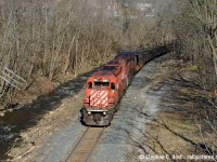 Leading a rail train, a pair of old soldiers rolls downgrade along the Grindstone Creek in Waterdown where a telegraph pole hangs precariously in the balance. I wonder if flooding or washouts has been an issue for the CP along here given how close that water is to the right of way.