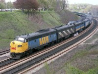 
This was a typical Sunday night at Bayview Junction some 40 years back;taking in the enjoyment of watching impressive passenger trains snake their way up and down the line.  Typical in this time frame is #75, shown here, westward, with VIA 6534, 6612, 6870 and 6516 and 18 coaches; a period when passenger trains really looked like passenger trains. It is a shame how the service has been neglected, chopped up by various governments and incompetent management. Note that, compared to today; the hillside is clear, there is little trash; the parking lot is full as once it was free to come and enjoy the parkland settings your taxes paid for.  This was a wonderful area to enjoy the sweet light of the evening....back then.