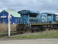 I decided to post this as a follow-up to Geoff Elliot's really nice country setting photo with #2456 in the lead, photo #45134. It was great to see an old X-LMSX on the lead; but this image presented shows not all in that series are so lucky to be out there on the line.
At the old Martech facility in Welland, a number of CN locomotives are to be stored for scrap, either on site or elsewhere I am not sure which. Here we see CN 2455, a "fallen blue" about to be pushed across Rusholme Rd by company Centre cab #615 into the the Martech fenced compound to await its' fate. This is the end of the line. Quite a few more units there will eventually meet the same demise.