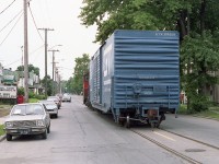 It has been about 7 years since I posted a shot of CN 7724 rumbling down Welland Av in St. Catharines with one car in tow, heading for the GM Plant on Ontario St. ( photo #12027). Well, finally, found a "going" shot of same; and it does look pretty good.
Street running is a rare thing these days.  This view is looking SW on Welland Av, just having crossed over Niagara St intersection. To me, this idyllic street scene appears a lot older than it is.