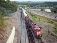 I'm up on the McQuesten bridge (aka: The High Level) looking toward the Hwy 403 and have captured a couple of shots of a trio of MLW C-424s leading a train; which is something I would never pass up. Not even back then. I am thinking this must be the daily 271 (270's counterpart) that ran up the hill to the Jct and west on the run from Binghamton to Chicago. Power is CP 4228, 4219 and 4214.  Construction is for future anticipation of GO Transit traffic.