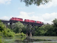 CP power as I used to enjoy it. A continual mixture.  Here, we have CP 5794 (SD40-2), 4742 (M-636) and 4230 (C-424) with train #507, a Toronto to Detroit daily that interchanged with CSX. I noted it was a nice day down by the old "swamp pond", but rather hot and humid.  This really lazy "river" looks so idyllic. 