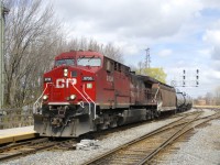 CP 9736 was freshly repainted a couple years ago but is currently quite filthy as it leads ethanol train CP 650 under a signal gantry and past Lasalle Station.