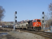 CN X306 with CN 3071 up front and CN 3102 mid-train splits a pair of signals as it approaches MP 3 of CN's Montreal Sub.