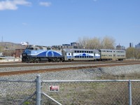 Gallery cab car AMT 900 is on its way from the EXO Pointe St-Charles Maintenance to Exporail as it passes MP 4 of CN's Montreal Sub. This car is being donated to the museum and will get there via CP's Adirondack Sub.