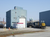 The local power is at rest in the Transflo yard in Beauharnois on a warm Saturday afternoon. In the background at right is the St-Clément Catholic church, which was completed in 1845. At left is the smokestack of what remains of the Spexel paper mill. Built in 1912, It closed in 2004 and was demolished in 2020 after a fire damaged it. It produced Canadian currency for numerous decades.