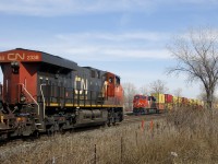 GEVO's meet as CN 368 with CN 2338 leading is about to pass a parked CN 106, with CN 3885 on the tail end.