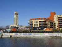 CN 4729 & CN 4774 are heading east light to pick up grain empties at Ardent Mills. At left is the Atwater Market, completed in 1933.