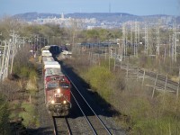 CP 119 heads west with Mount Royal looming in the background. Power is CP 8902 and CP 8156 up front and CP 8200 mid-train.