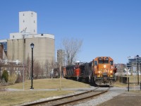 A crewmember is about to flag a fairly new pedestrian crossing as the Pointe St-Charles Switcher does some moves at Ardent Mills as they pick up grain empties.