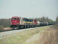 The rather short lived influx of oil trains thru Niagara brought a lot of photographers out while it lasted. These trains became almost regular at two a week, plus return empties; and suddenly they were gone. What can be seen along the Galt sub nowadays are not only less frequent, they also lack the interesting power of the SD40-2 lashups.
This is a typical run, as seen approaching mile 23 and the Welland Yard; SOO 6033, ICE 6444, 6419 and CP 5964.