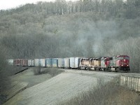 Bit of a hazy day; sun was called for, but it was busy along the hill at Dundas Mile 2. Drifting down is CN 5615, 4114, UP 7893 and WC 7495 as train #382.  CN did a lot of shoring up along here in the previous year and the landscape was still barren, making for some good angles. And better the next year when some vegetation filled in the hillside, but now, like many places that used to open, this location is a lost cause for photography.