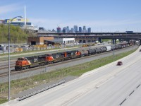 CN 2301, CN 2620 & CN 8955 are the power on a 103-car CN 321 as it passes the skyline of downtown Montrea