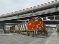 The Pointe St-Charles Switcher is shoving a single boxcar towards the Kruger plant as it passes over the Notre-Dame Street crossing and underneath the recently rebuilt Turcot interchange. Power is very clean CN 9410 and very faded CN 4774.