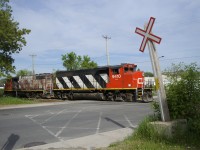 After setting off one car in the siding, CN 9410 & CN 4774 are heading back east so they can throw a switch and go grab a car from the Kruger plant. On the scanner. the crew could be heard talking about how this crossing of Monk Boulevard (which they have to manually flag) is the most dangerous one in the territory.