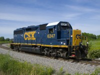 CSXT 6247 has left the Transflo facility in Beauharnois at the start of CSXT B786's shift as it heads towards the main line. Underneath the side window is a logo of some kind saying 'New York Central Boston & Albany'.