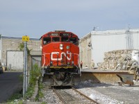 The Pointe St-Charles switcher is setting off boxcars at the Kruger recycling plant, located at the end of the short Turcot Holding Spur. The conductor can be seen walking back so he can inspect the cars to make sure that they are properly secured and that their are no objects stuck between the cars and the dock.