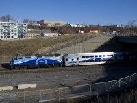 A cab car is leading and AMT 1342 is shoving as EXO 1202 from Mascouche ducks under an overpass.