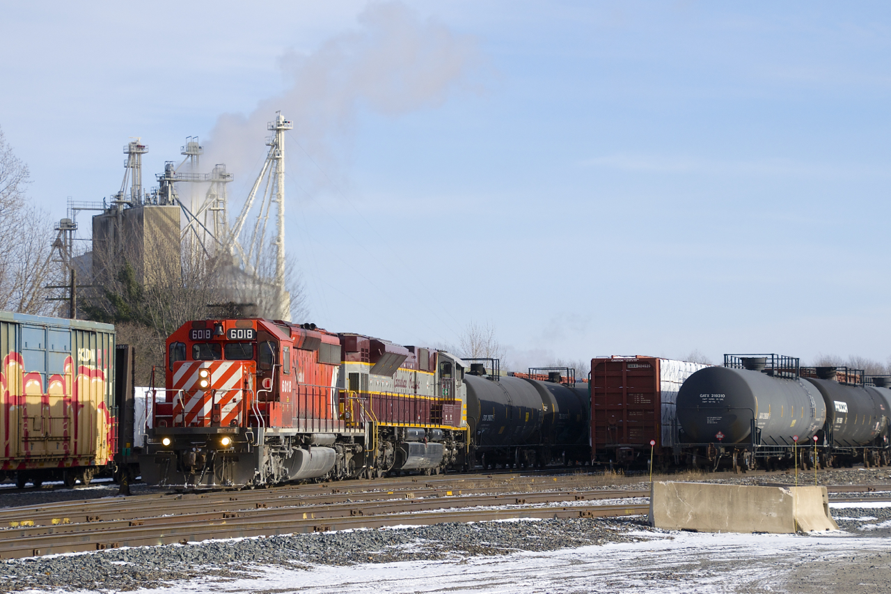 CP 6018 & CP 7011 are the power on CP 251 as it backs into Farnham Yard. In the background at left is the Robitaille feedmill.