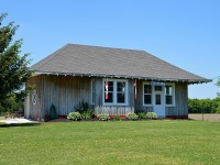 In 1872 what became the Grand Trunk pushed thru the little community of Ainsleyville, Ontario and the town name after was changed for reasons unknown to me to Brussels. 
This little station served the line for many years; eventually it was moved to become the clubhouse for the town lawn bowling group. I remember visiting and the station was painted red.  Now, it has become the Optimist Club office and thankfully not altered, sits in quiet retirement.
Location is on road 12 on the north-east edge of town.