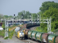 VIA 63 is overtaking empty grain train CN 875, which has just departed Turcot Ouest after a crew change. CN 875 has a solid set of MGLX hoppers up front, followed by Canpotex cars.