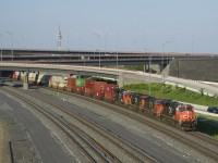 A 618-axle long CN 121 is emerging from the Turcot interchange on a scorching evening. Power is CN 2238, CN 2648, CN 2254 and CN 3262 up front and CN 2288 mid-train.