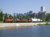 Consecutively numbered GP38-2's (CN 4706 & CN 4707) are shoving seven cars towards the Ardent Mills at right. Six of them are grain loads for the mill, while the first car behind the power is for O-I Canada, where this train will go when they are done here.