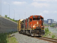 The Pointe St-Charles Switcher is heading to the Kruger plant with a single boxcar and CN 4706 & CN 4707 for power as they approach a level crossing at Notre-Dame Street.