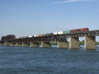 CP 9836 & CP 9808 lead a slightly late CP 253 over the St. Lawrence River on a sunny morning.