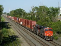 A 598-axle long CN 121 is approaching Taschereau Yard with CN 3174 and CN 3907 up front and CN 2843 mid-train. It will do work in the yard before continuining towards its terminus of Toronto.