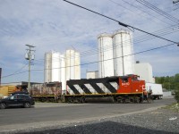 The conductor has gotten back on lead unit CN 9410 after flagging Place Turcot as the Pointe St-Charles Switcher leaves the Kruger plant.