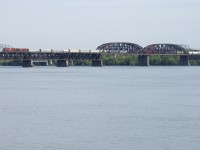 An SD70ACU is leading as CP 251 approaches dry land with CP 7044 & CP 8923 for power.