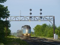 Park car <i>Banff Park</i> is on the rear of VIA 69 as it passes underneath a vintage and endangered signal gantry in Coteau.