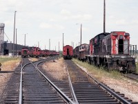 A view looking toward the engine facilities in Mac Yard back in mid 1984. Closest two units on the right are MLW S-7s, retired; numbers 8228 and 8230. Just another day at Mac.