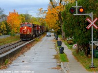 Before changes near downtown Guelph, L533 is running along Kent St approaching the now closed Dublin St crossing. L533 makes the occasional daylight appearance after outlawing in Kitchener, but usually it's against the sun so a cloudy day like this is perfect. Five units on this L533, a C44, T4 GEVO, looks like another C44 and a pair of dash 9's including a cowl, but I stand to be corrected, I can't find my notes. The foliage downtown attracted me of course, as it has for a long time. Since this photo was taken a fence was added along the concrete barrier separating the road and railway, and the crossing signals are gone.