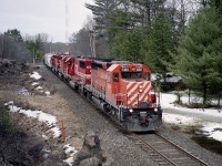 So I head north on a sunny morning only to get skunked by the cloud off Georgian Bay. Common happening. Despite conditions, this image was rather nice; CP 5811 leading SOO 6049, CP 5997 and 6009 heading north (read: west)and  made for a worthy image.
Rosseau Rd is a very popular location for photographers, as just to the east by less than a hundred feet is the CN line. So it is the best of both worlds thru here.
Caveat: Winged objects in the springtime. Flies and mosquitos voracious. There is a reason why I was there when snow was still on the ground.