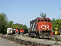 GMD power is parked behind the Coteau Station, with CN 9411, CN 4715 and CN 9454 visible (CN 4802 is out of sight behind CN 4715). In not too long the crew of CN 536 will come on duty and start their work with CN 4715 & CN 4802 for power. They will also couple CN 9411 to CN 9454.