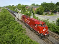 Fresh rebuild CP 8208 (ex-CP 8560) leads ethanol train CP 650 past a pair of signals in Pointe-Claire.