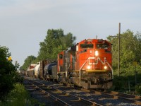 After lifting cars at Coteau, CN 321 is almost in Ontario as it passes through the small town of Rivière-Beaudette on a summer evening. Power is CN 8963 & CN 5732, an entirely decent lashup, especially by current CN standards.