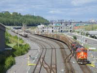 Empty potash train CN 731 has a new crew onboard and is about to depart Turcot Ouest with CN 3872, CN 2906, CN 2808 and 206 cars. At left is a large cut of grain cars.